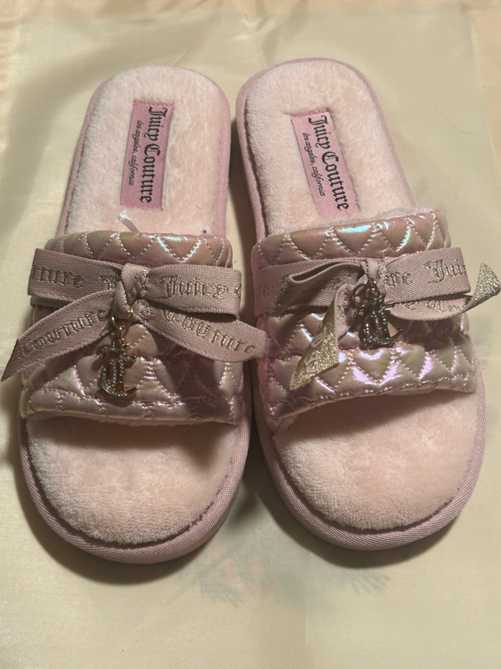 Juicy Couture's Shimmery Light Pink Quilted Slide Slippers with Bow Charm